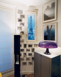 On either side of a photograph by Torbjorn Rodland are Elysées sconces by Pierre Paulin. A lighted Bouroullec vase sits atop a vintage Raymond Loewy storage unit.