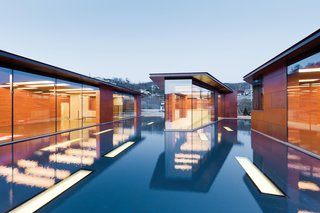 Clad in copper panels that Holl had fabricated by the Kansas City, Missouri, company Zahner, the house is daylit by a host of rectangular skylights (inspired by the musical staff) punched through the roofs and the pool’s floor.