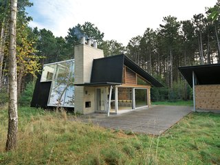 After living on and studying a woodsy acre of land in North Zealand, Denmark, architect Jesper Brask cleared a stand of pine trees and, from the timber, built a getaway open to its surroundings. The house, which Brask shares with his wife, Lene, and sons, Kristian, Jens, and Niels, is used mainly in summer, when the weather is optimal for throwing open the glass doors.