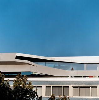 Sweeping diagonals cut across the façade of House Ray 1 to provide privacy and a modicum of safety for a dramatic outdoor terrace.