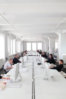 All Phifer’s 25 employees work around a hundred-foot table. Phifer maintains the monochromatic palette down to the mouse pads.