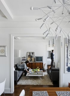 Up on the ninth floor, their sober Neo sofa and chaise from DWR and classic Florence Knoll credenza are contrasted by more exotic accessories like Patrick Townsend’s Orbit chandelier and an offbeat white vase from Creative Growth, an Oakland, California, workshop for disabled artists.