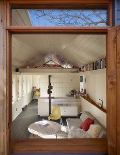 Light cascades into the living room through a row of six insulated timber windows on the south wall. The north wall flares out to create what Schaer calls a sunset scoop. "It grabs the late afternoon and evening sun and brings it deep into the space," he explains.