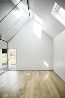 Danish Farmhouse Turned Contemporary Art Studio - Photo 6 of 6 - Inside the studio lies a spacious, light-filled interior. It is the perfect place for Søren’s comedy shows, sketches, and music, but also provides a calm, pleasant space shared by the whole family. "Our kids enjoy being in there and playing or falling asleep on the floor as well," says Lone.