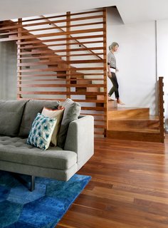 Julie Fisher on How to Shop for Furniture - Photo 2 of 2 - In the George Street Residence, architect Julie Fisher designed a custom walnut staircase. She selected a Honeycomb rug from One King’s Lane and a Bensen Edward sofa from ID Chicago to outfit the living room.