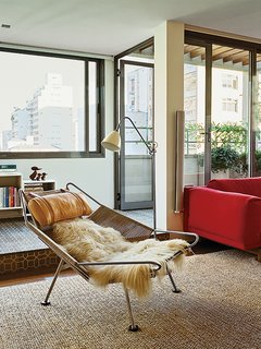 10 Ways to Bring a Little “Hygge” Into Your home - Photo 1 of 10 - A Flag Halyard chair by Hans Wegner in long-haired sheepskin occupies one end of this living room.