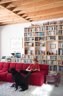 Wes Mahony lounges on a Tufty-Time sofa by Patricia Urquiola for B&B Italia in the family room that architect Emily Jagoda created for his family in their tree-damaged garage in Santa Monica.