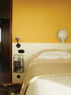 Modern Home Furnished With Flea Market Finds - Photo 5 of 17 - Farrow & Ball’s Babouche yellow enlivens one of the bedrooms.