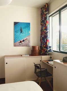 Modern Home Furnished With Flea Market Finds - Photo 7 of 17 - The desk and cabinets in one bedroom are custom, and the chair is Patrick Norguet for Tolix.