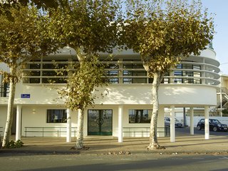 Modern Home Furnished With Flea Market Finds - Photo 9 of 17 - The structure is characteristic of the town's architecture. The city was rebuilt by modernist architects from the nearby Bordeaux school after it was destroyed during World War II.
