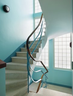 Modern Home Furnished With Flea Market Finds - Photo 10 of 17 - The apartment can be reached by a winding staircase.