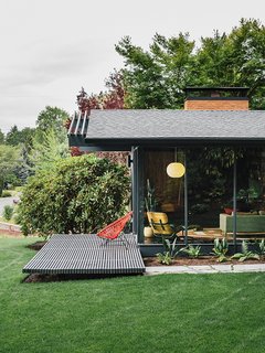 Speaking to his original design, architect Saul Zaik says, "We were really just building boxes with a bunch of windows but experimenting with how you integrated indoor and outdoor spaces." The house has seven different openings to the exterior, allowing different courtyard or patio settings for a range of outdoor activities, including seating for a gathering on the street-facing side. The Milfords hired Lilyvilla Gardens for the landscaping around the house, including variegated bluestone steps with thyme joints.
