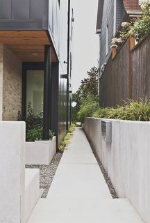 Green and Affordable Structure Fits Three Families in One 28-Foot-Wide Lot - Photo 9 of 11 -