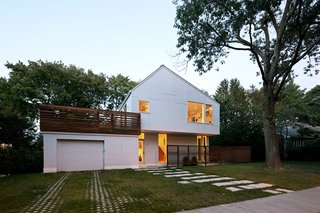 To maintain a sense of scale with regards to the lot, the Braver house was built up, down, and back. Through a series of split-levels, the previously one-story home is now three-and-a-half levels, with much of the new square footage reaching into the backyard.<br><br>The asymmetrical angle of the roof’s pitch isn’t architectural whimsy. Instead, it simultaneously hides an array of solar panels from view while optimizing its angle to the sun.