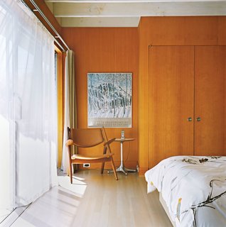 Sheer curtains let light and breezes into the master bedroom.
