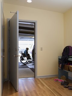 The architects created a mudroom off the garage with plenty of room for quick turnarounds and busy family comings and goings. Much of the garage had been taken up by a large ramp before the concrete floor was repoured on a slope that meets with the house, eliminating the need for a more cumbersome ramp and allowing room for storage shelves. "Your home is a place where you shouldn’t have to put out too much effort, whether you’re a person with a disability or not," says Braitmayer. "You should be able to reserve all that energy and effort for the outside world."