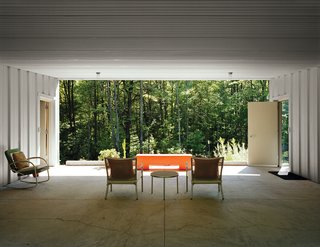 Cook and Compa turned a carport into a breezeway, adding patio furniture and an orange bench to give the space a dash of color. Along with the patio, it adds 1,300 square feet of usable space during the warmer months.