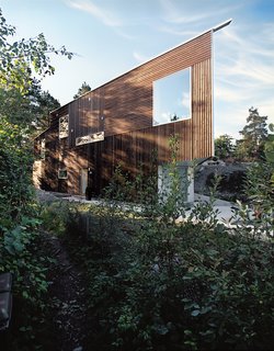 The Triangle House was completed in 2006, and its natural materials and geometric form equally embrace the surrounding forests and ocean. Photo by Ivan Brodey.
