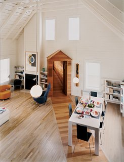 The great room's high, pitched roof and neutral walls give the space an open, tranquil feel, making it a desirable spot for the couple to pursue two of their passions: classical music and literature.