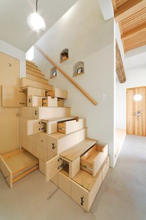 10 Dazzling Modern Staircases - Photo 5 of 10 - We love it when a functional stair is also packed with storage, so we immediately fell for this staircase in Koriyama, Japan, that was designed by architect Kotaro Anzai. Cabinets under stairs, or kaidan dansu—as they're called in Japan—are common in traditional Japanese architecture. The cabinets are made out of linden plywood, while the treads made out of ash. 