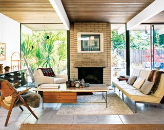 In the living room, a travertine-topped coffee table by Paul McCobb pairs well with the Florence Knoll Parallel Bar System sofa. The Josef Albers print over the fireplace is an original, scored on eBay.