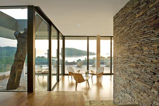 The living room, sports a trio of Shell chairs by Hans J. Wegner for Carl Hansen & Son.