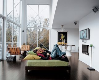 The couple lounges in their great room. The 16-foot-high windows are from Milgard.