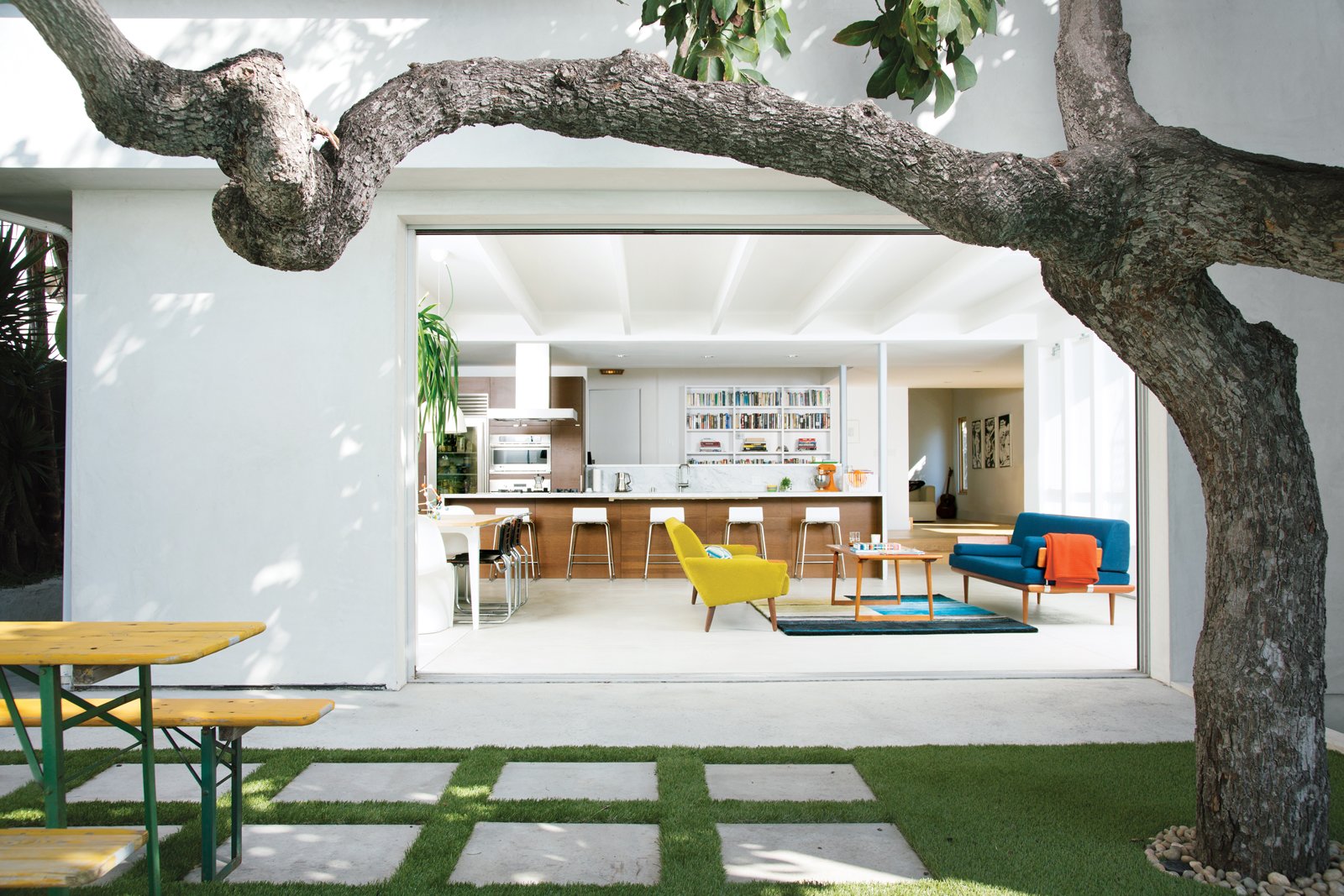 A mature avocado tree shades the hardscaped patio located just outside the great room.