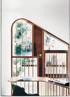 Almost Perfect - Photo 4 of 8 - The delicate wooden dowels, used both on the exterior facade and the mezzanine level balustrade, are nods to the bamboo fences traditionally found in tea gardens.