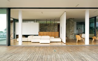 A sliding wall in the living room pivots 90 degrees to reveal a small space near the door and to close off part of the room.