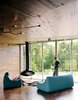 New Grass Roots
With its corrugated-aluminum exterior, X House in Hennepin, Illinois, was built to resemble rural silos. The inside, however, features rich wood paneling and spare furnishings. From floor-to-ceiling windows, the residents have a view of the surrounding grassland. Photo 3 of New Grass Roots modern home