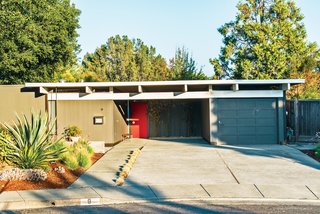 The exterior of Neely and Kefalides’s house is punctuated with a bright red door.