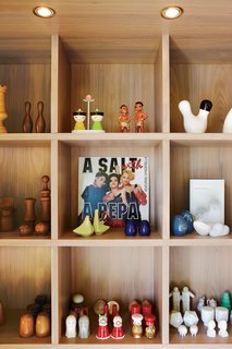 Montague arranges his objects with a sense of humor. Custom shelves display his collection of salt and pepper shakers.
