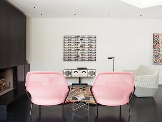 A pair of Slow chairs by the Bouroullec brothers for Vitra frame a new Brionvega RR226 stereo by Achille Castiglioni in the living room. The photograph by Michael Wolf of a Hong Kong apartment building is from a series that ran in the March 2004 issue of Dwell.