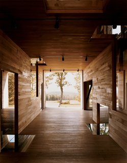 Raising the Barn - Photo 2 of 7 - In a narrow residual area between the breezeway and the house's northern elevation, Cohen created a so-called "skinny space," with a changing area accessible to the outdoor shower.