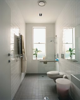 The bathroom’s width and reinforced handrails accommodate Wansbrough’s needs.