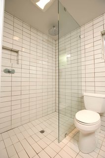 Popp removed the old bath/shower combo and remodeled the configuration of the shower, which now has one-level access for safety and ease of use, and installed a remote operating device. "The tile is all Heath seconds," says Popp, who found enough pieces to cover the entire 250-square-foot bathroom.
