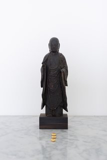 A Japanese Edo period statue sits in another part of the house. The rocks, created by Brothers, are covered in gold leaf.