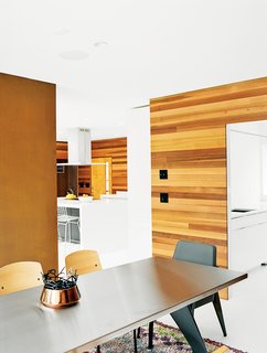 The Midcentury Spirit is Alive and Well in This Hudson Valley Escape - Photo 1 of 11 - The contractor, Tim Kimmel of Kimmel Builders, removed built-in shelving behind the stone fireplace and installed a Cor-Ten steel panel in its place. Vitra manufactures the Jean Prouvé–designed Standard dining table and side chairs.
