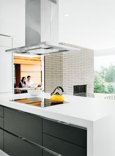 The Midcentury Spirit is Alive and Well in This Hudson Valley Escape - Photo 5 of 11 - The cooktop and oven are Miele, the counter-top is Caesarstone, and the refrigerator is Liebherr.