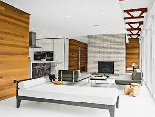Seeking an escape from bustling city life, a Manhattan couple embarked on a renovation in the verdant Hudson Valley. The Citrons inherited the Modernica sofa, chaise, and table from the previous owners. They added Jasper Morrison cork stools by Vitra. The cedar interior walls were inspired by the exterior cladding and are finished in orange oil beeswax by Howard.