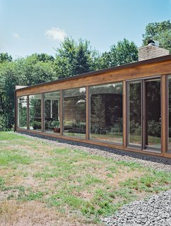 The Midcentury Spirit is Alive and Well in This Hudson Valley Escape - Photo 8 of 11 - He added floor-to-ceiling windows by Andersen, which allow low winter sunlight to warm the interior in colder months.