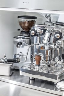 The coffee station features a professional-grade Rocket Espresso machine. Jang and King designed a stainless-steel pullout shelf for a cream and sugar station.