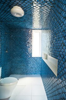 In the upper-level bathroom, tiles painstakingly fired by DeSimio cover the walls and ceiling.