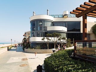 The glass-walled facade faces the Strand.