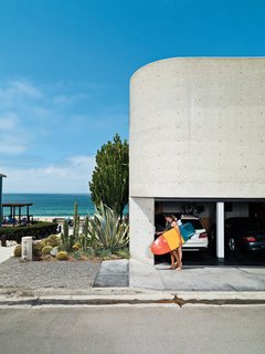 The streetside facade, dominated by site-poured concrete, contains the garage, from which Jacobson and Dukes escape for a quick surf.