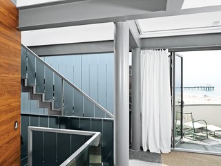 For the small terrace off the master bedroom, Dukes and Jacobson chose a Walter Lamb bronze rocker and ottoman from Studio 111. The drapery fabric, typically used for boardshorts and therefore hardy enough for the salt air, is from Busch & Associates.