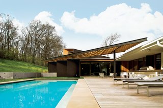 The Trellis That Keeps It Cool - Photo 2 of 2 - Katy Chudacoff, an interior designer at Dovetail Design Works, selected the outdoor furniture, like the poolside chaises and lounge chairs from Brown Jordan.