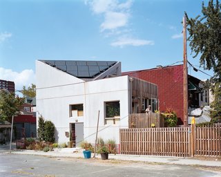 Eighteen insulated concrete panels, each a different size and shape, were trucked to the site and hoisted into place over three days. The outlines of eight of these panels can be seen when the house is viewed from the southwest.