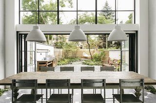 A Neglected Brooklyn Townhouse Becomes a Home That’s Primed for Entertaining - Photo 1 of 8 - The original home’s dilapidated rear wall was in such poor condition that Roberts called it "an opportunity in disguise." She removed the wall and built a two-story addition that features double-glazed windows and sliding doors for unified entertaining inside and in the garden.